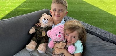 Navy Federal Branch Manager Mariska Kalmeijer Ruble’s kids cuddle their new bears.