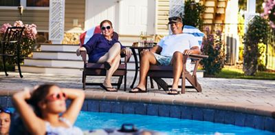 Mom and dad enjoy watching kids having fun in pool