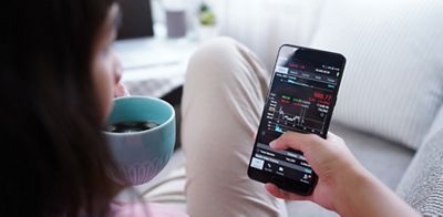 Woman invest online stocks trading on mobile platform app