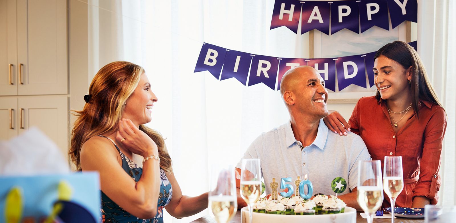 Father smiles at daughter while celebrating his birthday