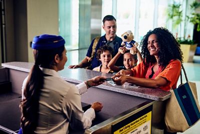 Family at the airport checking bags