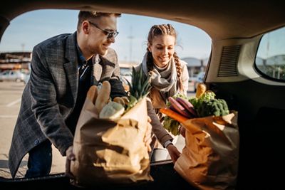 Beautiful young couple in love at parking lot after shopping