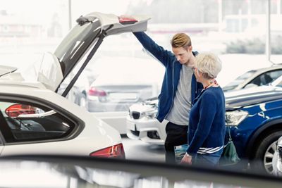 Young Man and Mom shopping for car 