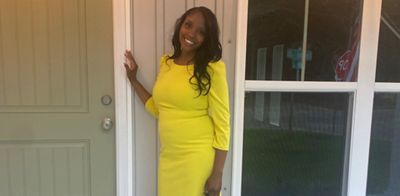 Jalissa Davis stands in front of the home she bought after joining Navy Federal’s member service team.