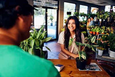 Woman making a plant purchase at Garden Center