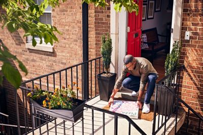 Man picking up pizza delivery to the house