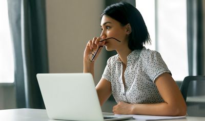 Thoughtful asian business woman looking away thinking solving problem