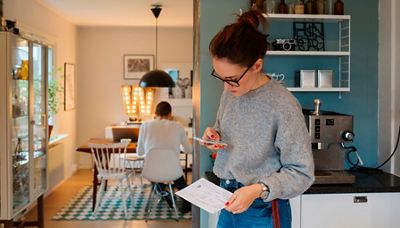 Woman paying bill on cell phone.