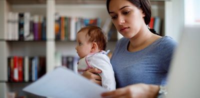 Young worried mother working from home