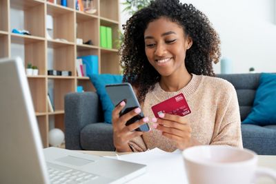 Black woman using credit card for online shopping