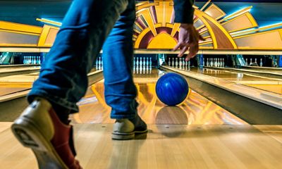 Close-up of the shoes of a bowler tossing the ball down the lane