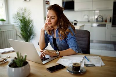 Smiling young woman working at home