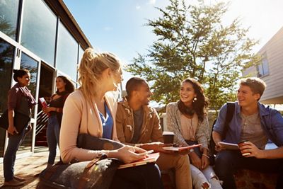 Shot of a group of students studying outside on campus