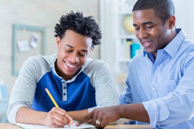 Father and son reviewing paperwork at the table