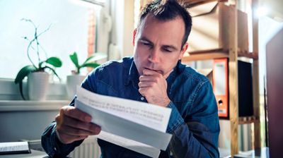 Worried man reading mail