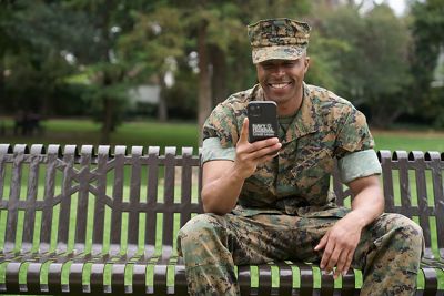 Marine mobile banking while waiting on a park bench